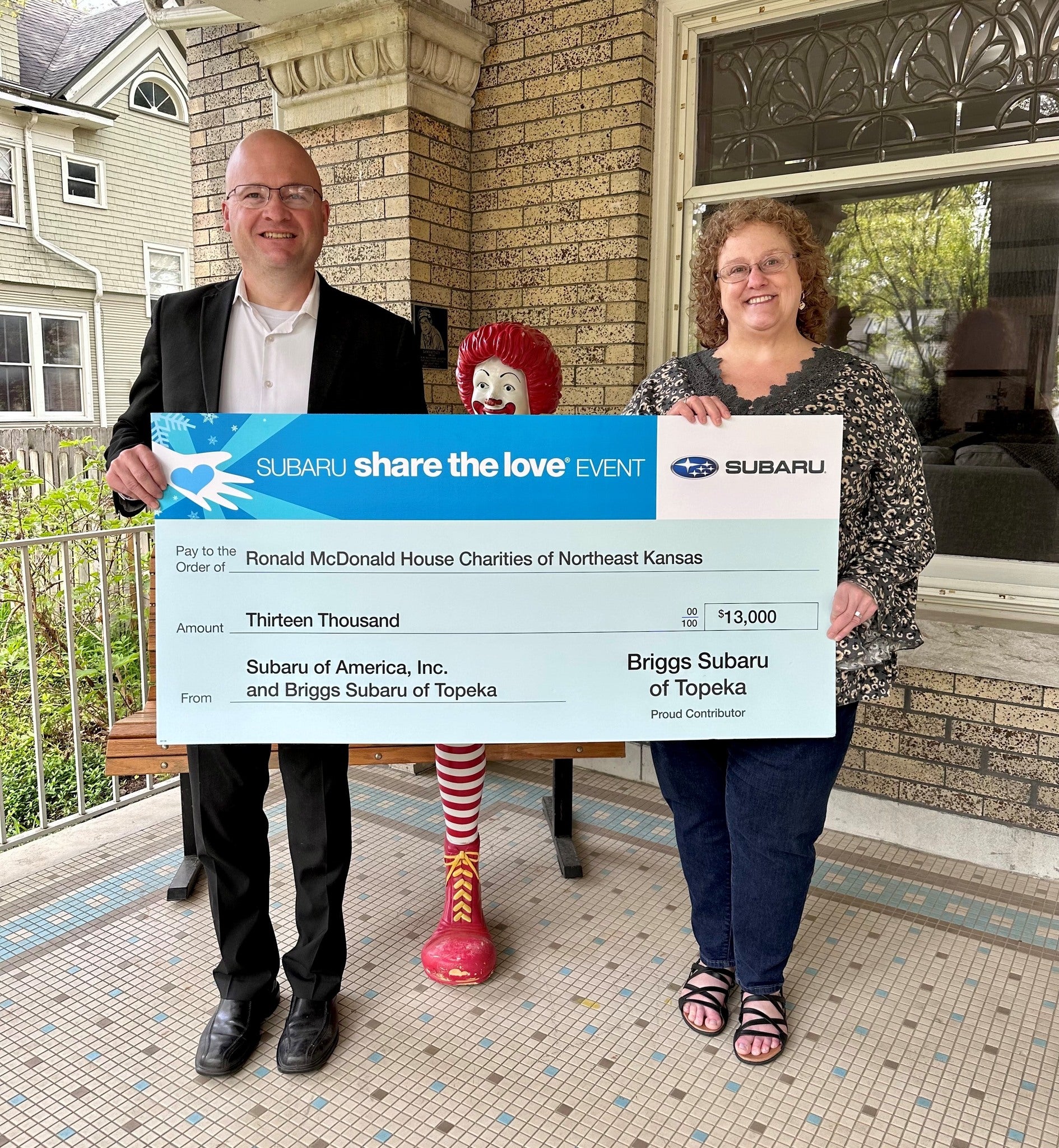 Delivering Big check to Ronald McDonald House
