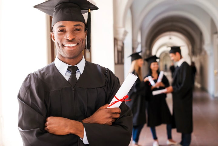 college graduate holding his diploma | Briggs Subaru of Topeka in Topeka KS