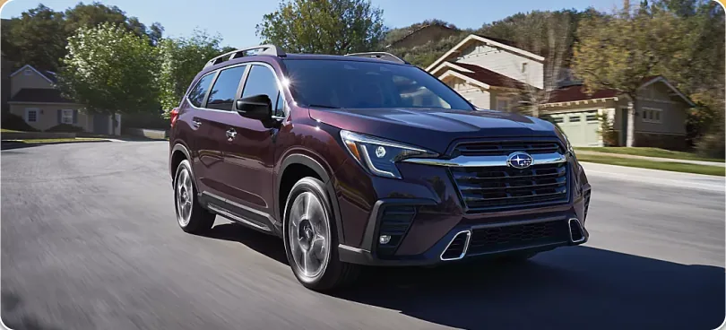 Maroon 2026 Subaru Ascent driving a residential street
