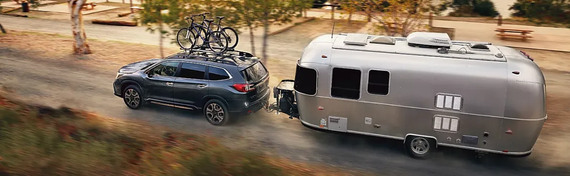 2026 Subaru Ascent towing an Airstream trailer with bikes on the roof