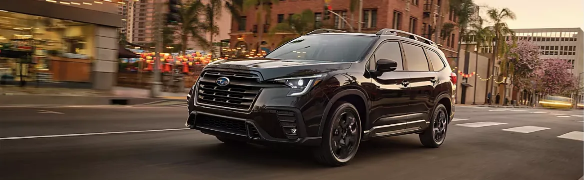 Black 2026 Subaru Ascent driving a palm-lined street