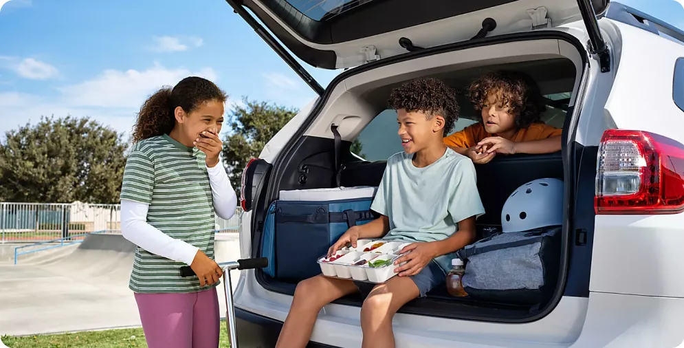Children seated in the open cargo area of a 2026 Subaru Ascent