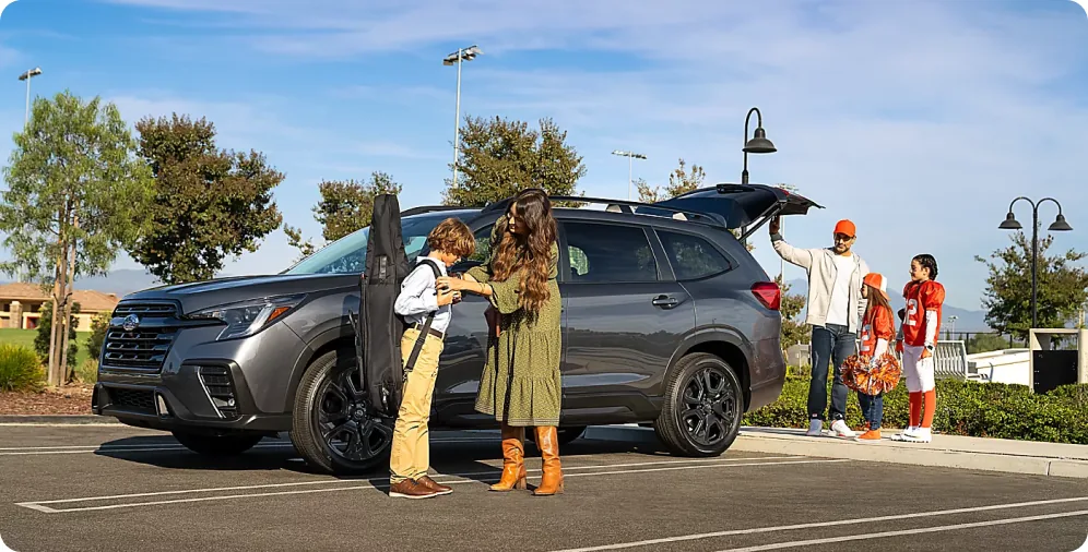 Family loading gear into a 2026 Subaru Ascent in the driveway