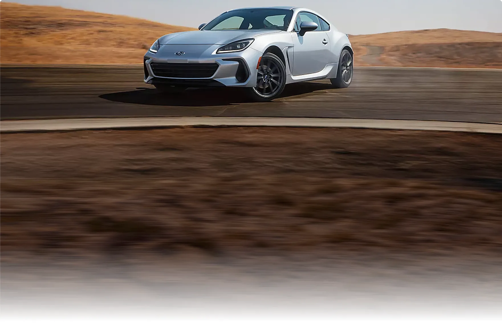 Front three-quarter view of a silver 2026 Subaru BRZ at speed