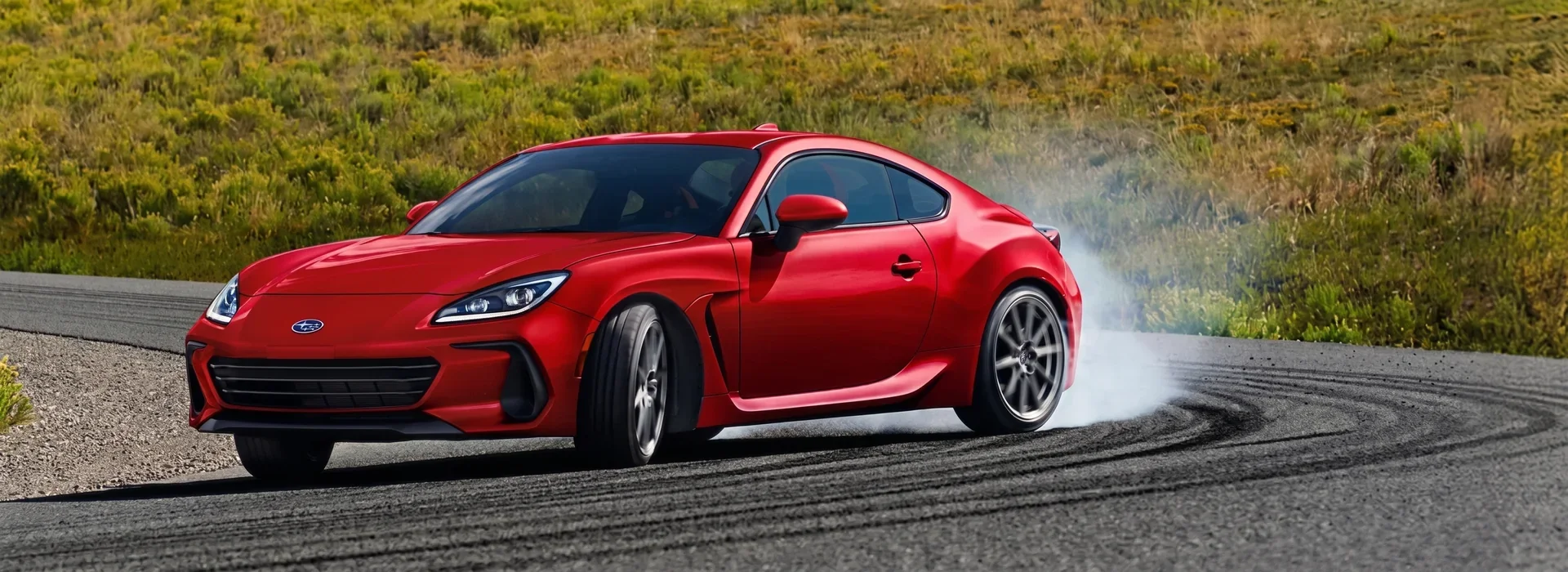 2026 Subaru BRZ sports coupe drifting through a mountain corner