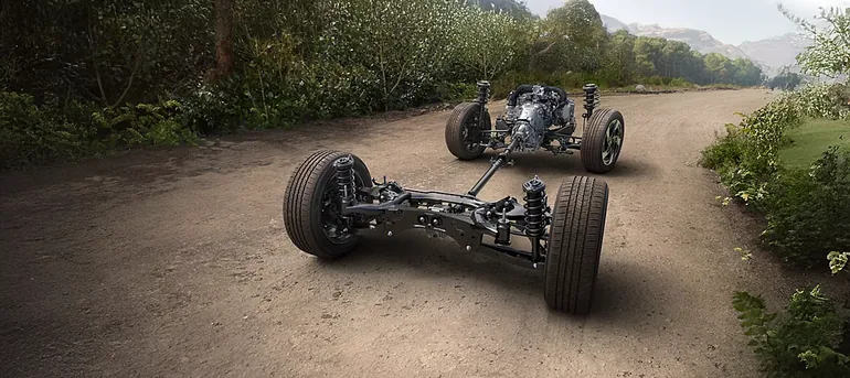 Subaru Symmetrical All-Wheel Drive drivetrain layout shown on a gravel road