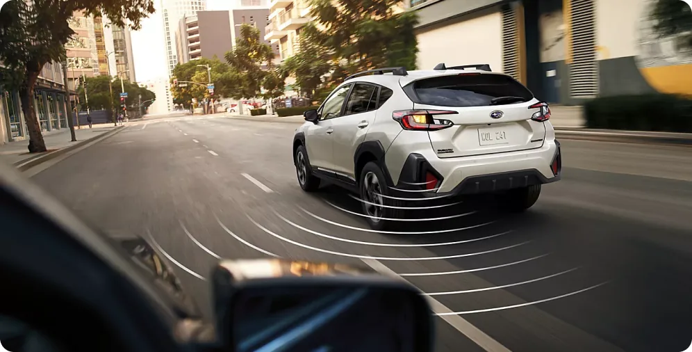 All-around awareness sensor field visualised around a white Crosstrek Hybrid in the city