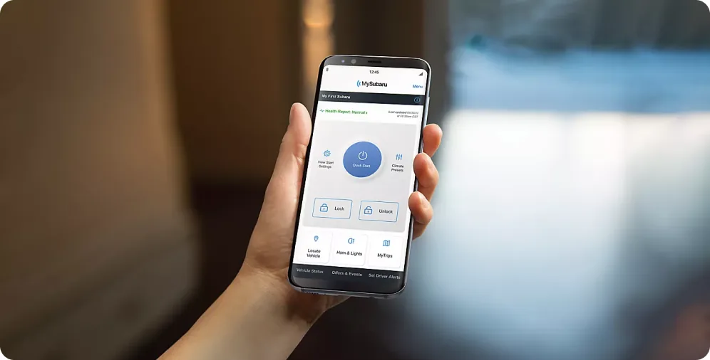 Hand holding a smartphone running the MySubaru app