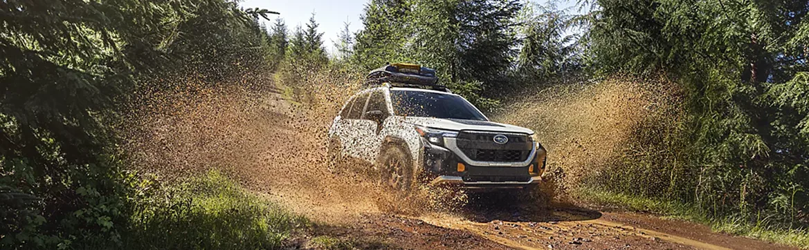 2026 Subaru Forester kicking up dust on a forest trail