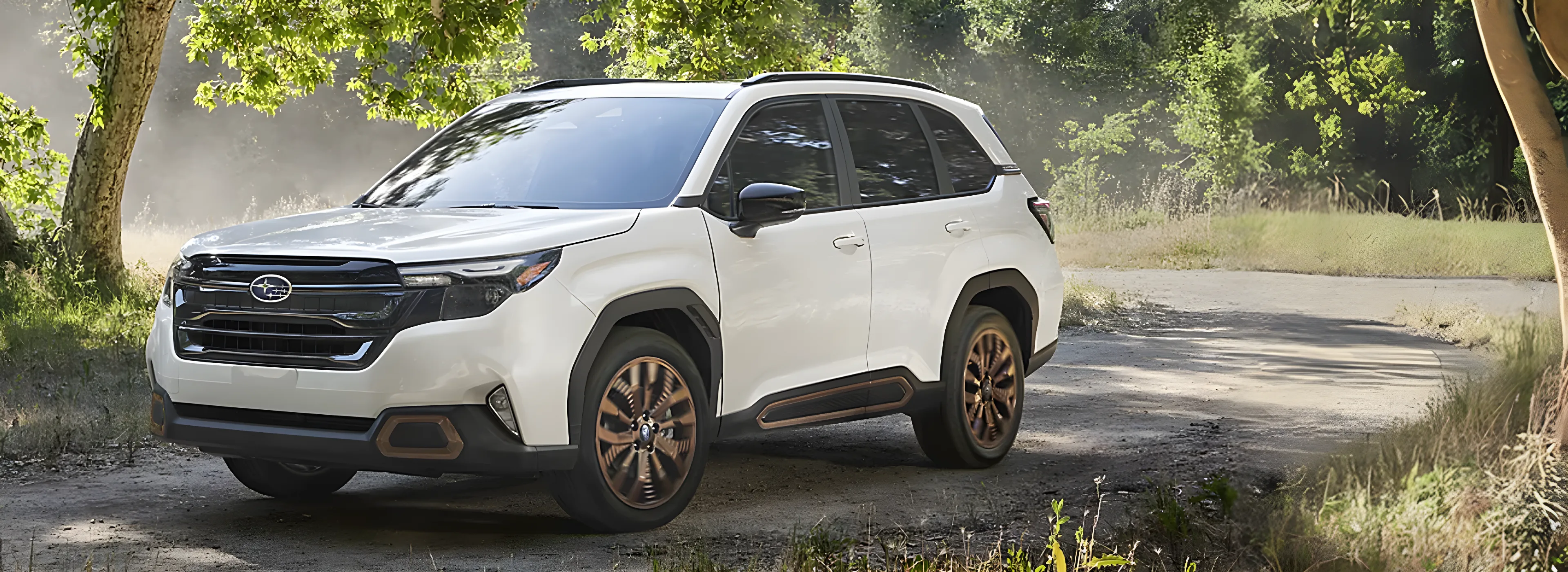 White 2026 Subaru Forester on a wooded dirt trail