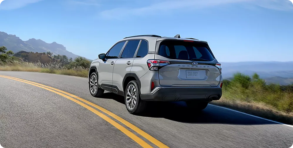 Silver 2026 Subaru Forester on a winding mountain road