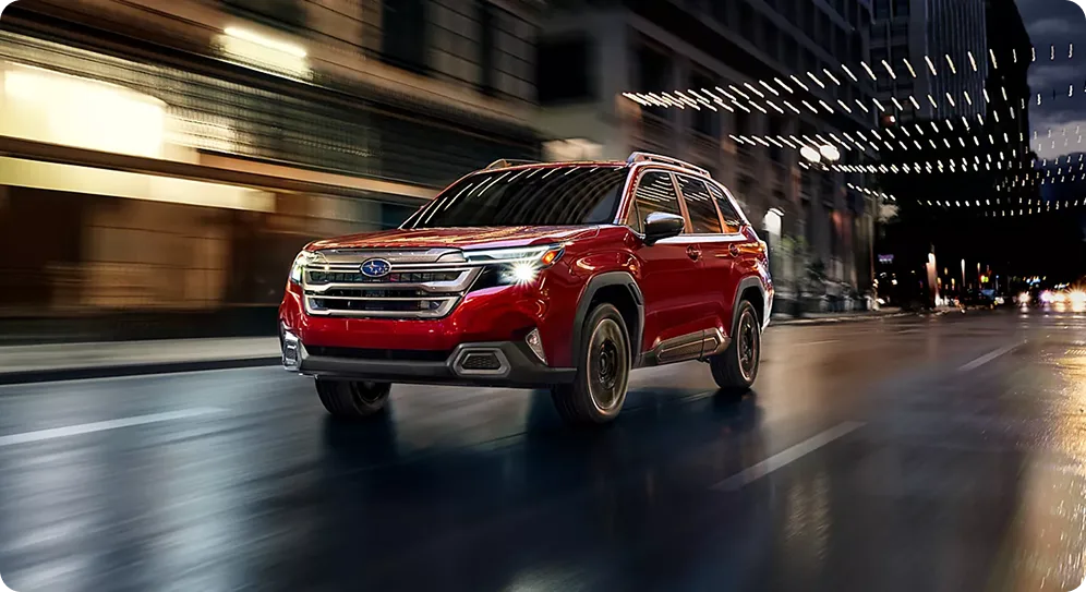 Red 2026 Subaru Forester driving at night