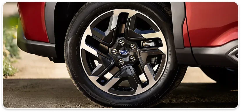 Alloy wheel and body cladding detail on a red 2026 Subaru Forester