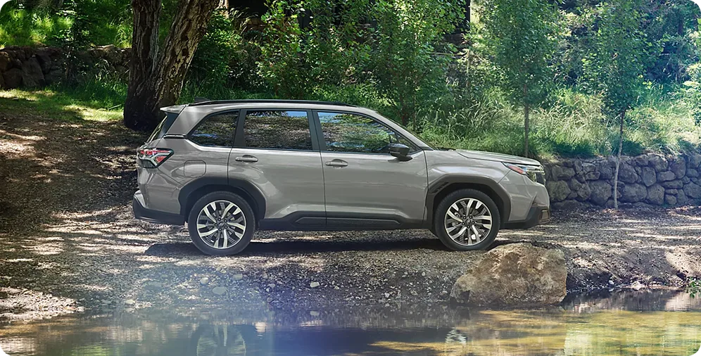 Silver 2026 Subaru Forester crossing a shallow rocky stream