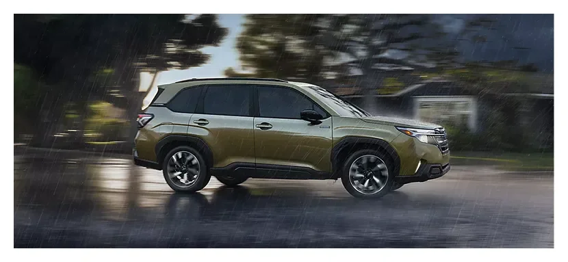 2026 Subaru Forester Hybrid driving on a rain-soaked road