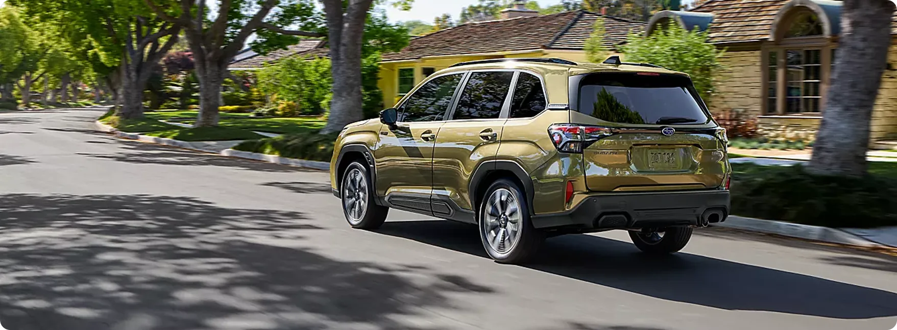 2026 Subaru Forester Hybrid driving through a suburban neighborhood