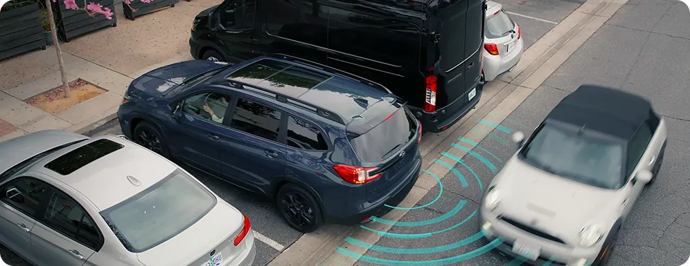Rear Cross-Traffic Alert sensing passing traffic as a Subaru reverses out of a parking space