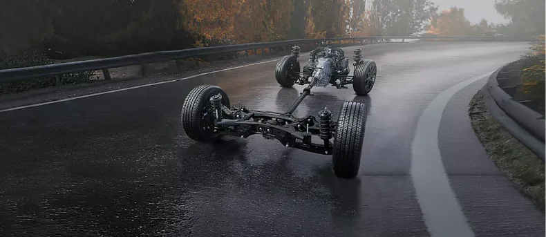Subaru Symmetrical All-Wheel Drive layout shown on a wet road