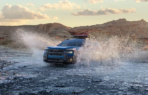 Subaru Outback splashing through deep water