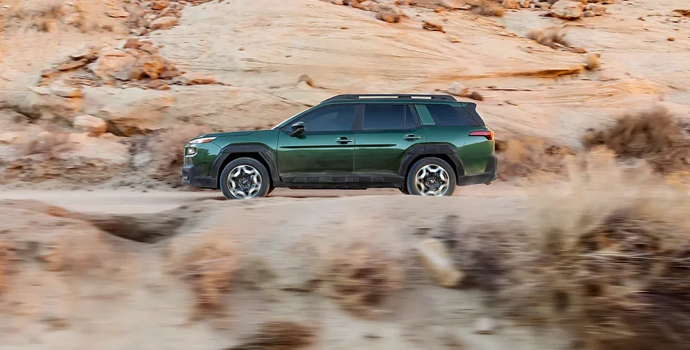 Side profile of the 2026 Subaru Outback on a rock ledge