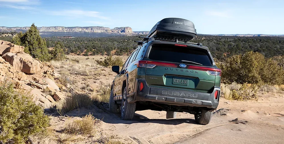 2026 Subaru Outback climbing a rocky incline with X-MODE engaged