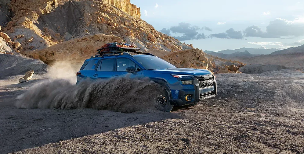 2026 Subaru Outback Wilderness kicking up dust on a mountain trail
