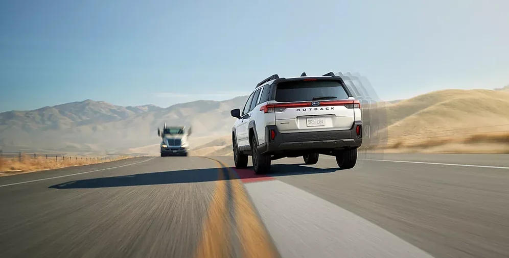 2026 Subaru Outback driving on an open desert highway