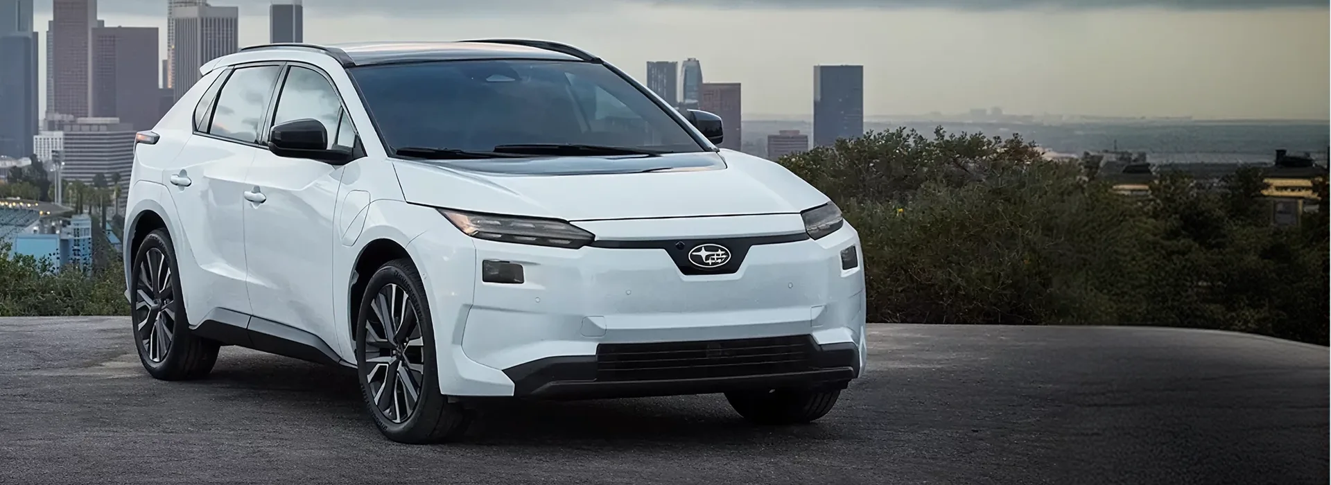2026 Subaru Solterra all-electric SUV parked above a city skyline