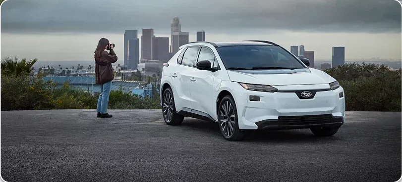 White 2026 Subaru Solterra parked at a city overlook