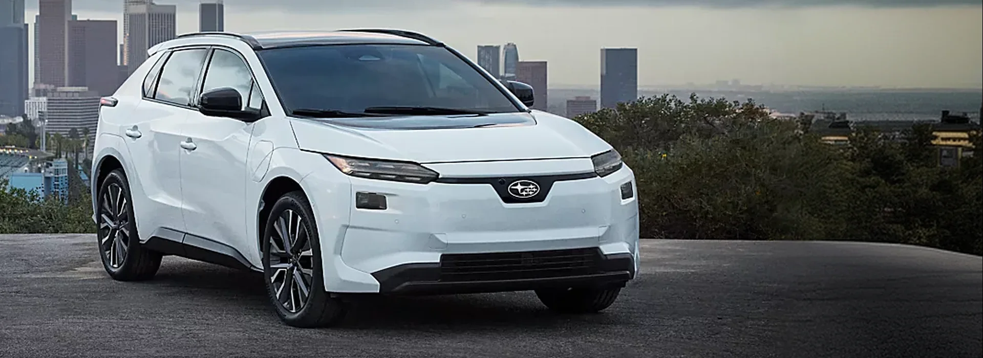 2026 Subaru Solterra all-electric SUV parked above a city skyline