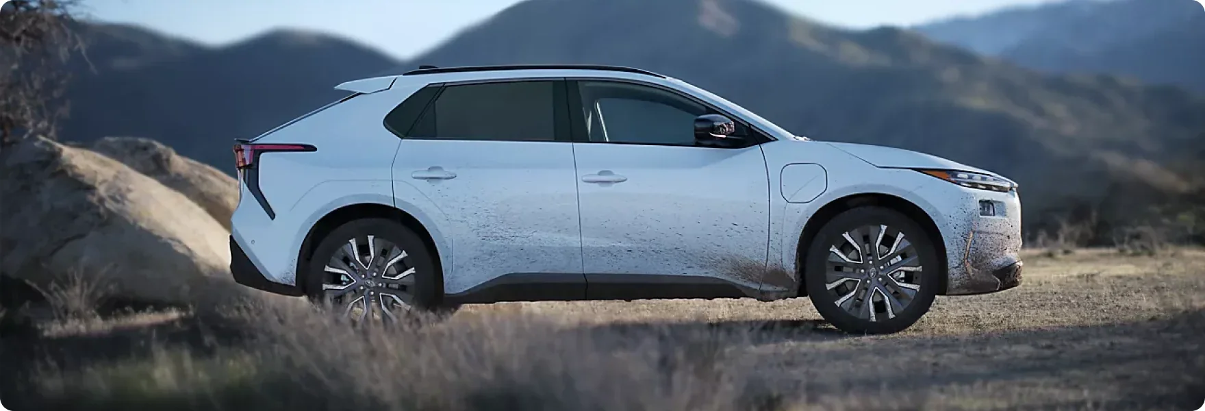 Profile of a white 2026 Subaru Solterra XT parked on a mountain ridge
