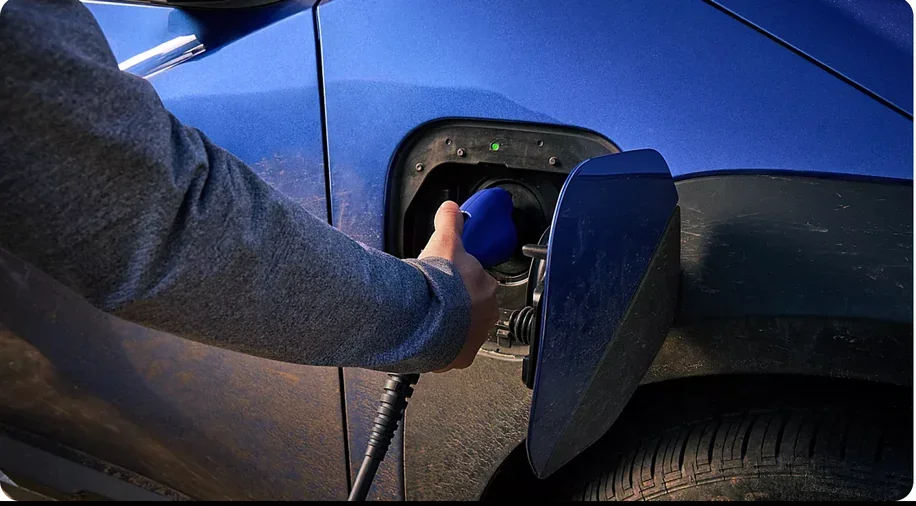 Driver plugging a charging cable into a 2026 Subaru Trailseeker
