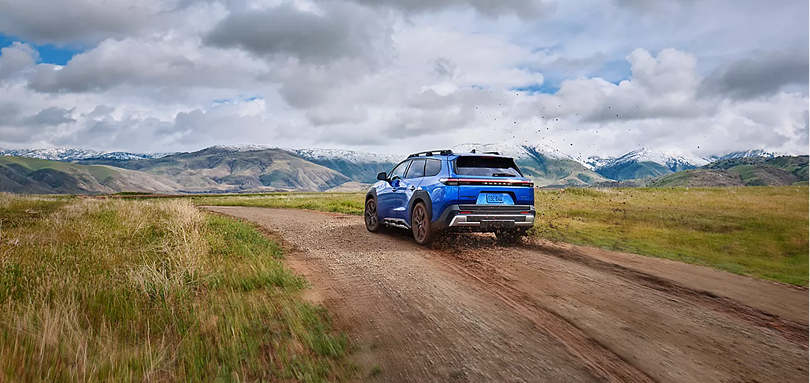2026 Subaru Trailseeker heading away down a gravel road toward the mountains