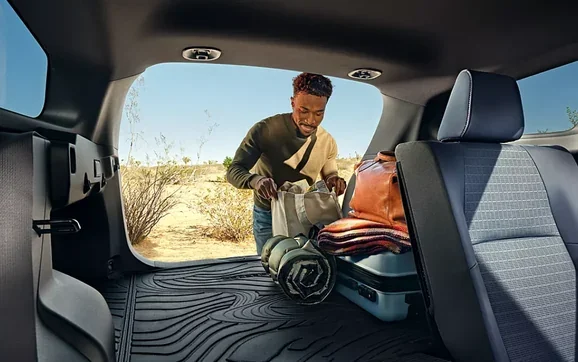 Loading gear into the rear cargo area of the 2026 Subaru Trailseeker