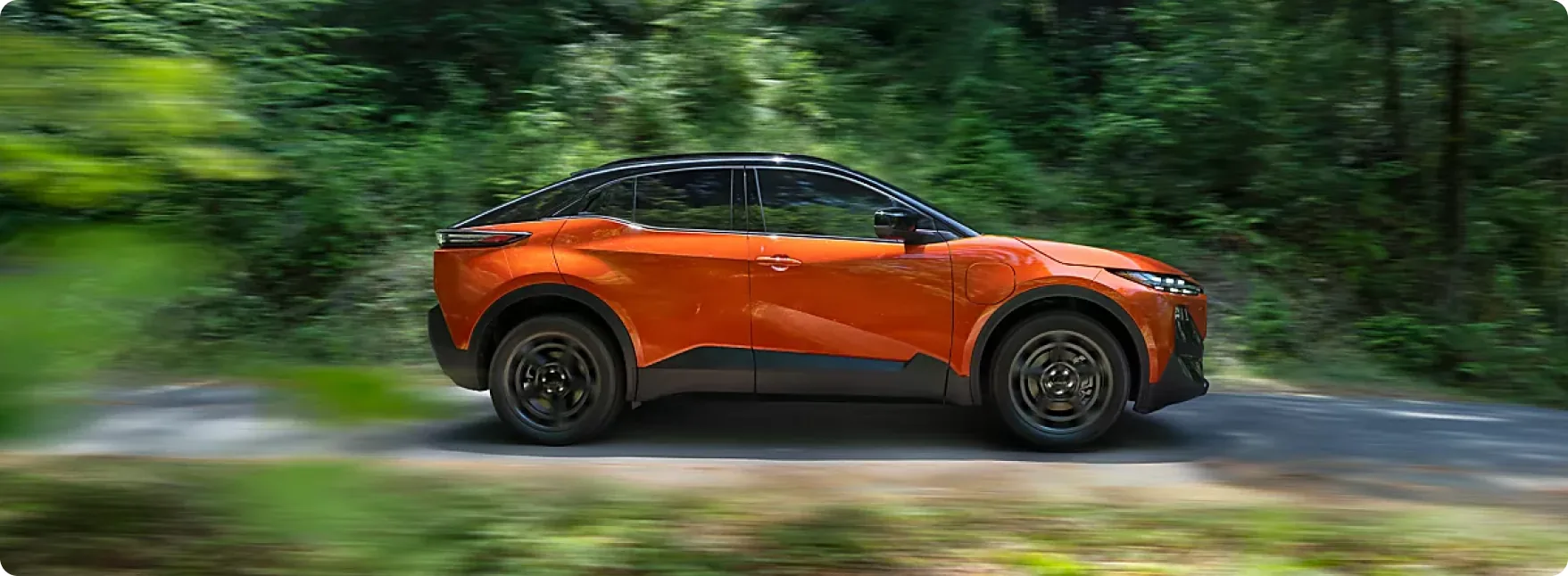 Orange 2026 Subaru Uncharted at speed on a forest road
