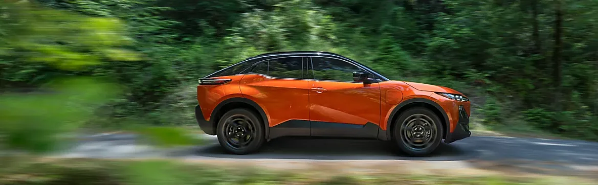 Side profile of an orange 2026 Subaru Uncharted in motion