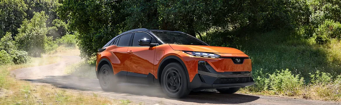 Orange 2026 Subaru Uncharted kicking up dust on a country trail