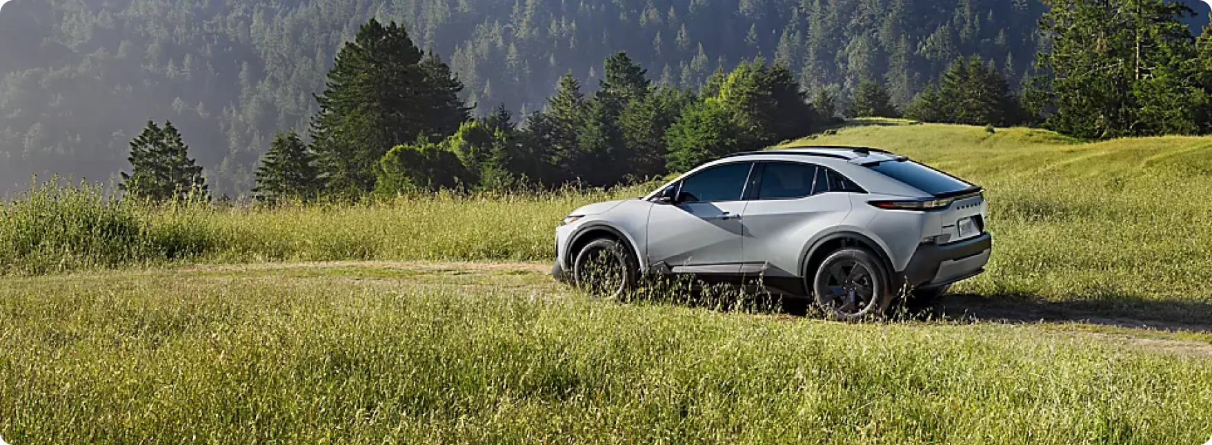 2026 Subaru Uncharted parked beside a forest trail on a clear day