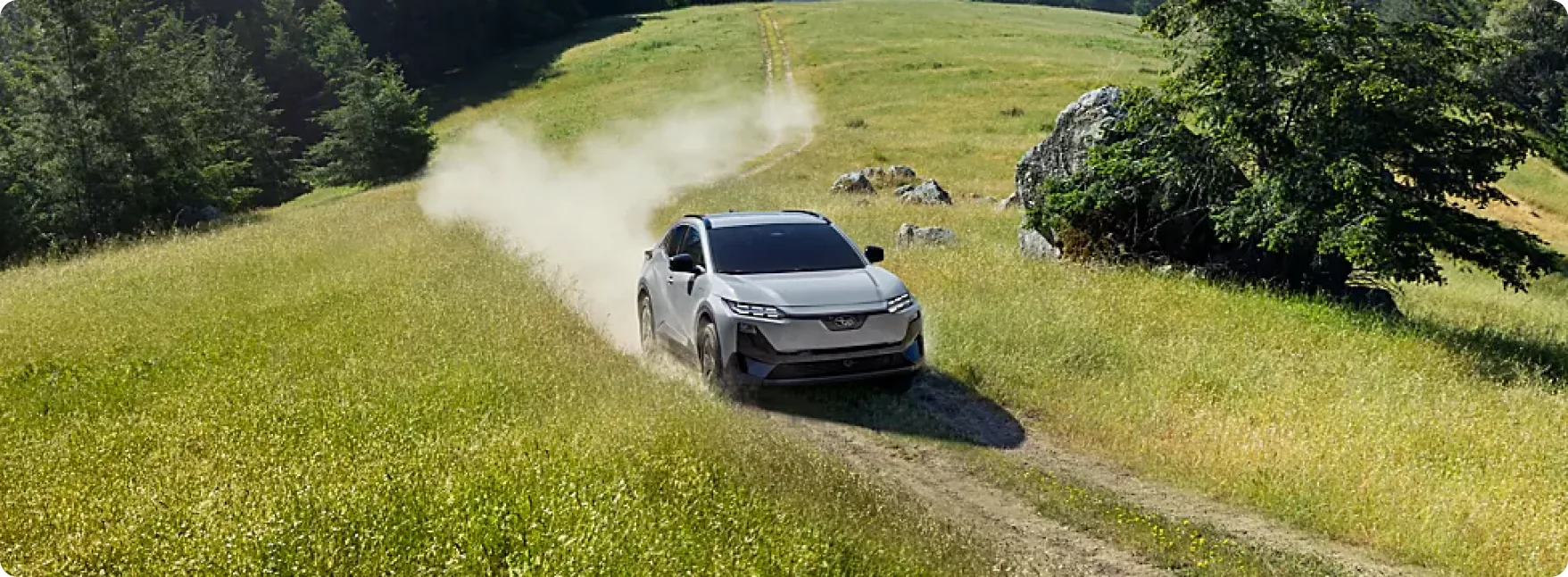 2026 Subaru Uncharted on an open road framed by rolling countryside