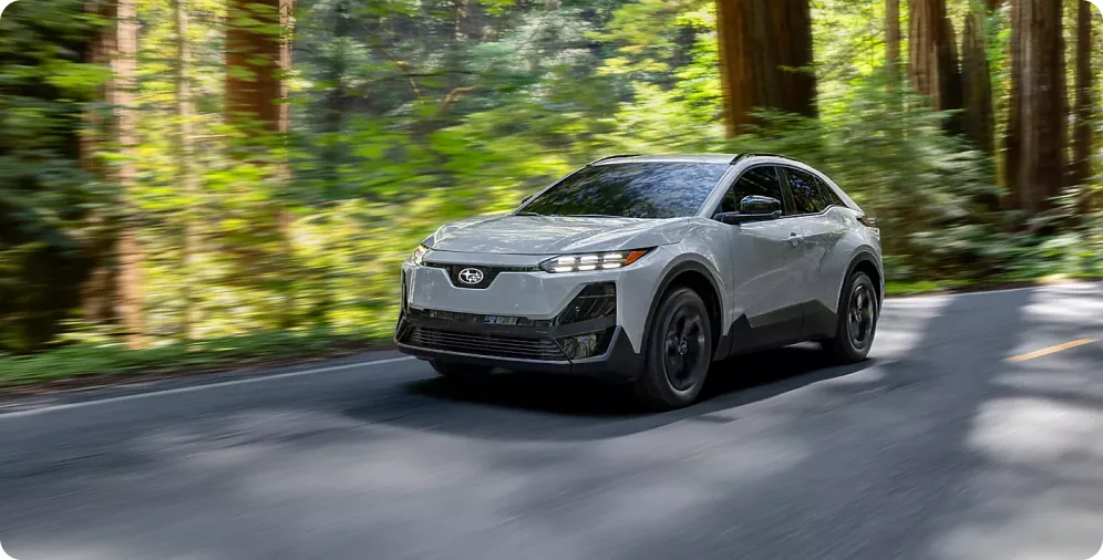 2026 Subaru Uncharted accelerating through a forest highway