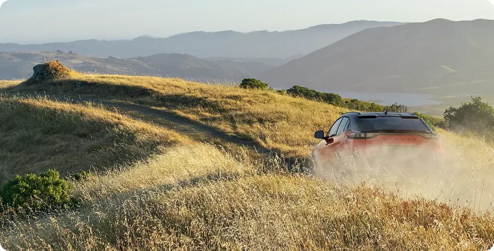 2026 Subaru Uncharted cresting a golden hillside trail at sunset