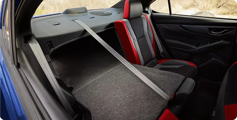 60/40-split rear seatbacks folded flat to open up the trunk of the 2026 Subaru WRX