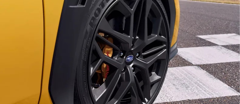 Matte-black-finish wheel and Brembo brake caliper on the WRX Series.Yellow