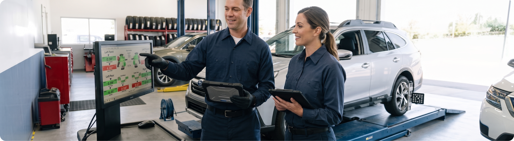 Subaru trained and certified technicians reviewing wheel alignment readings at Briggs Subaru of Topeka