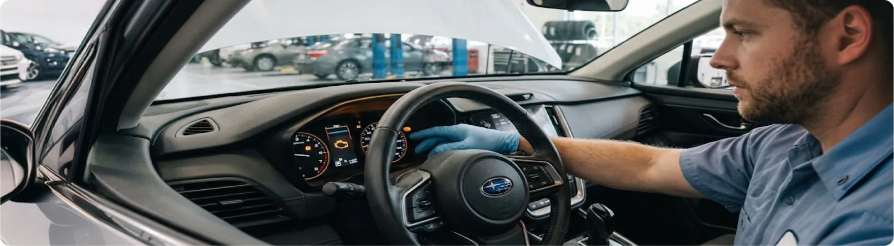 Subaru trained and certified technician checking the dashboard warning lights inside a Subaru at Briggs Subaru of Topeka