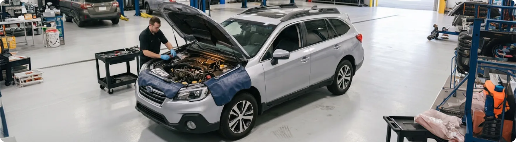 Briggs Subaru of Topeka technician working at the front of a Subaru Outback engine during a reseal service